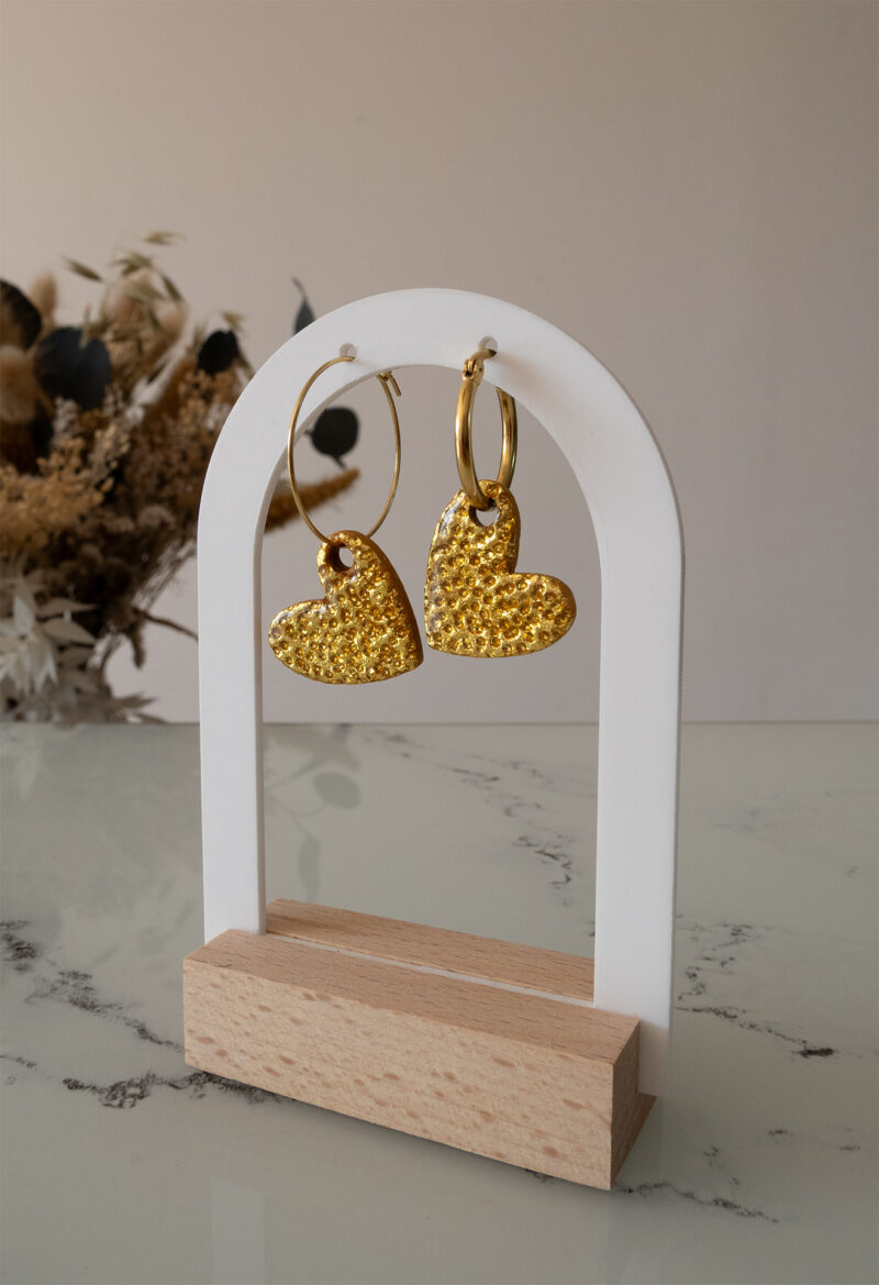 Apportez une touche d’élégance romantique à votre tenue grâce aux créoles avec cœur interchangeable, Aimée. Ces boucles d’oreilles artisanales se distinguent par un joli cœur asymétrique en feuille d'or martelé à la main, posé sur une créole dorée ou argentée à choisir selon vos préférences. Polyvalentes, ultra légères et confortables, elles sublimeront aussi bien une tenue décontractée qu’un style plus sophistiqué.