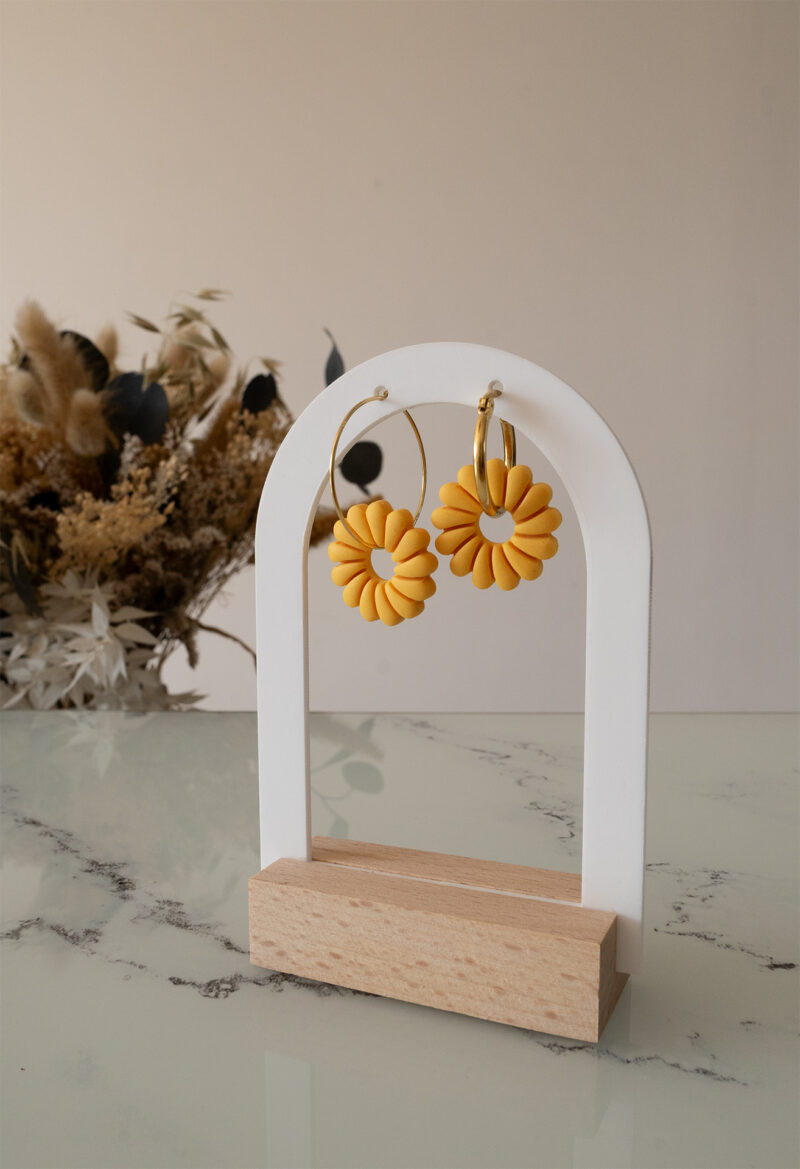 Apportez une touche de luminosité à votre tenue grâce aux créoles avec soleil interchangeable, June. Ces boucles d’oreilles délicates se distinguent par un soleil jaune modernisé posé sur une créole dorée ou argentée, à choisir selon vos préférences.