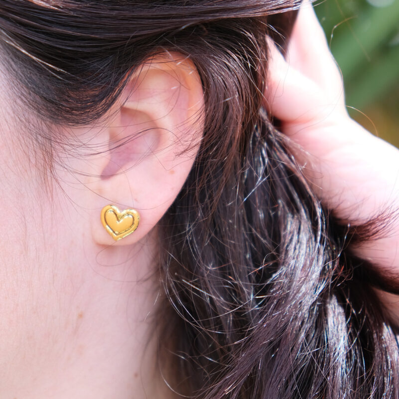 Découvrez Vicky, des puces d’oreilles en forme de cœur qui célèbrent la délicatesse et la féminité. Malgré leur petite taille, ces puces font un maximum d’effet. Chaque cœur en argile polymère arbore une texture subtile et irrégulière, ornée de touches de feuille d’or jaune, rose ou d’argent, comme si leur surface avait été doucement grattée pour révéler une lueur précieuse en dessous. Discrètes mais éclatantes, les puces d’oreilles Vicky sont légères et faciles à porter, même par les enfants.